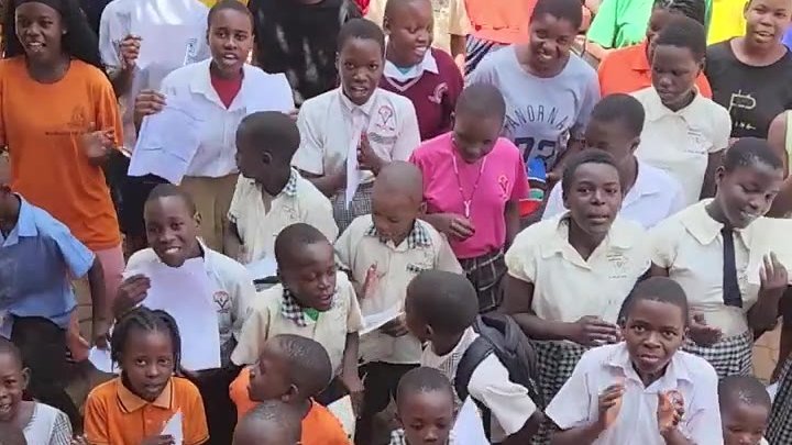 The Mercy For Life Africa Children’s Choir singing in the school courtyard